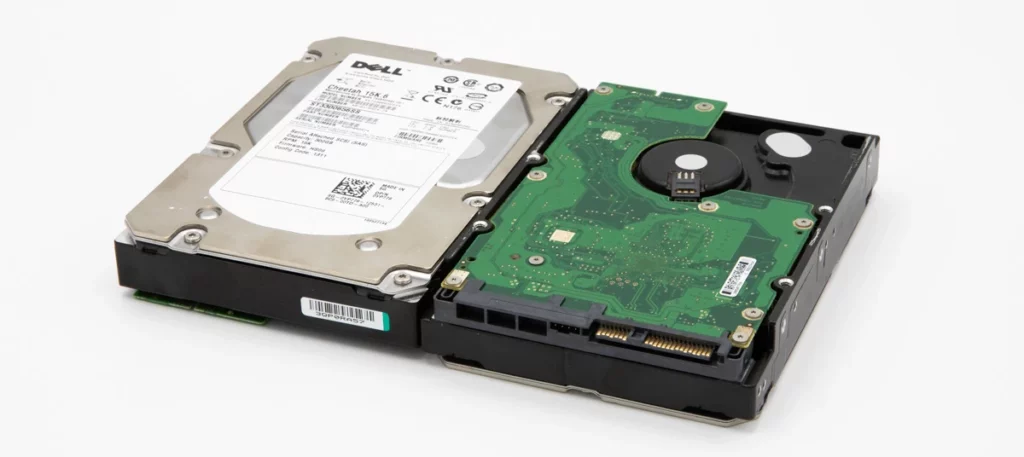 Two Dell hard drives placed side by side, showing front label and green circuit board