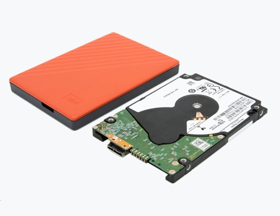 Disassembled orange WD external hard drive with cover and internal drive.