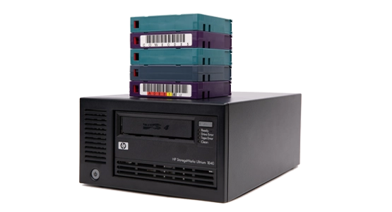 HP StorageWorks Ultrium tape drive with a stack of data cartridges on top