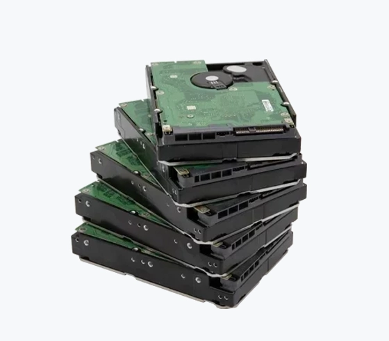 A stack of multiple internal hard drives with visible green circuit boards and black casings.